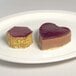 A heart shaped pastry on a white plate.