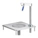 A white square Delfield water station with a metal pole and metal square drain, and a stainless steel sink with a metal blue handle.
