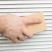 a hand holding a sponge