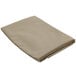 A folded beige Intedge table cover.