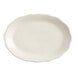 An ivory oval platter with a scalloped edge.