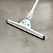 A white Unger SmartFit floor squeegee with a green and white telescoping handle.