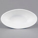 A white oval porcelain dish with a white rim.