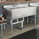 A white stainless steel Regency underbar sink with three compartments and a right drainboard.