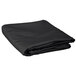 a folded black blanket on a white background