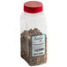 A plastic container of Regal Old Fashion Pickling Spice with a red lid filled with spices.