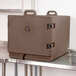 A dark brown Cambro insulated tray carrier on a metal shelf.