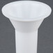 A white plastic sausage stuffer funnel.