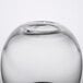 A clear glass Libbey votive candle holder with a black rim on a table.