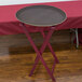 An American Metalcraft mahogany wood tray stand holding a tray on a folding table.