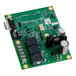 A green circuit board with small black and white objects.