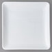 a white square plate on a gray background