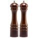 Two brown wooden Chef Specialties pepper mills.