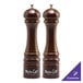 Two brown wooden pepper mills with the word "savor" on them.