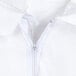 A close-up of a zipper on a white coverall.