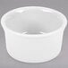 A white Fiesta china ramekin on a gray surface.