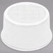 A Fiesta white china ramekin on a gray surface.