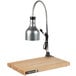 A Cres Cor portable carving station with a lamp over a maple wood cutting board.