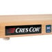 A Cres Cor maple wood cutting board with a logo on it.