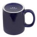 A blue mug with a white rim and handle.