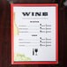 Menu paper with a wine themed column design on a table.