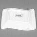 A white square CAC Miami porcelain plate with a wave design.
