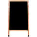 An Aarco oak A-frame sign board with a black marker board and wooden frame.