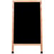 An oak A-Frame sign board with a black chalkboard.