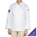 A woman wearing a white Chef Revival long sleeve coat with black piping.