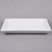 A white rectangular American Metalcraft stoneware platter on a gray surface.