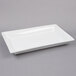 A white rectangular American Metalcraft stoneware platter on a gray surface.