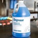 A case of Advantage Chemicals concentrated degreaser on a counter.