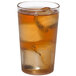 a glass of ice tea with ice cubes