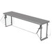 A grey metal rectangular self service food shield with glass shelves.