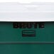 A close-up of a green Rubbermaid BRUTE recycling can with a white lid.