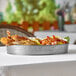 A Tablecraft stainless steel round platter with shrimp and crab on it.