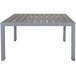 A BFM Seating standard height table with a metal base and synthetic gray teak top.