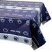 A blue and white Creative Converting Penn State University plastic table cover with paw prints on a table.