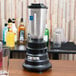 A Waring commercial bar blender on a table.