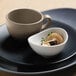 A sand-colored Libbey Driftstone porcelain plate with a cup and saucer on it.