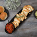 A Libbey Driftstone Onyx porcelain tray with a bowl of salsa and a plate of bread.