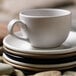 A stack of Libbey Driftwood satin matte porcelain bowls on a table.