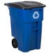 A blue Rubbermaid recycling bin with wheels and a black lid.