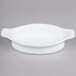 A white oval porcelain dish with handles.