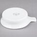 A white porcelain casserole dish with a handle.