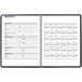 A black At-A-Glance weekly planner with a spiral binding and a calendar grid.