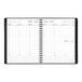 A spiral bound black and white At-A-Glance planner with a calendar on the cover.