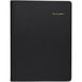 A black leather At-A-Glance weekly planner with gold text on the cover.