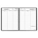 A spiral bound black At-A-Glance weekly planner.