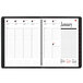 A spiral bound black At-A-Glance weekly/monthly appointment book cover.